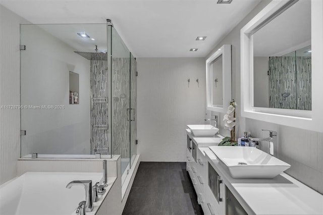 bathroom with independent shower and bath, tile patterned floors, and vanity