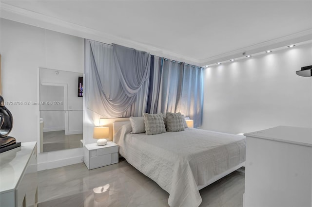 bedroom with marble finish floor and ornamental molding