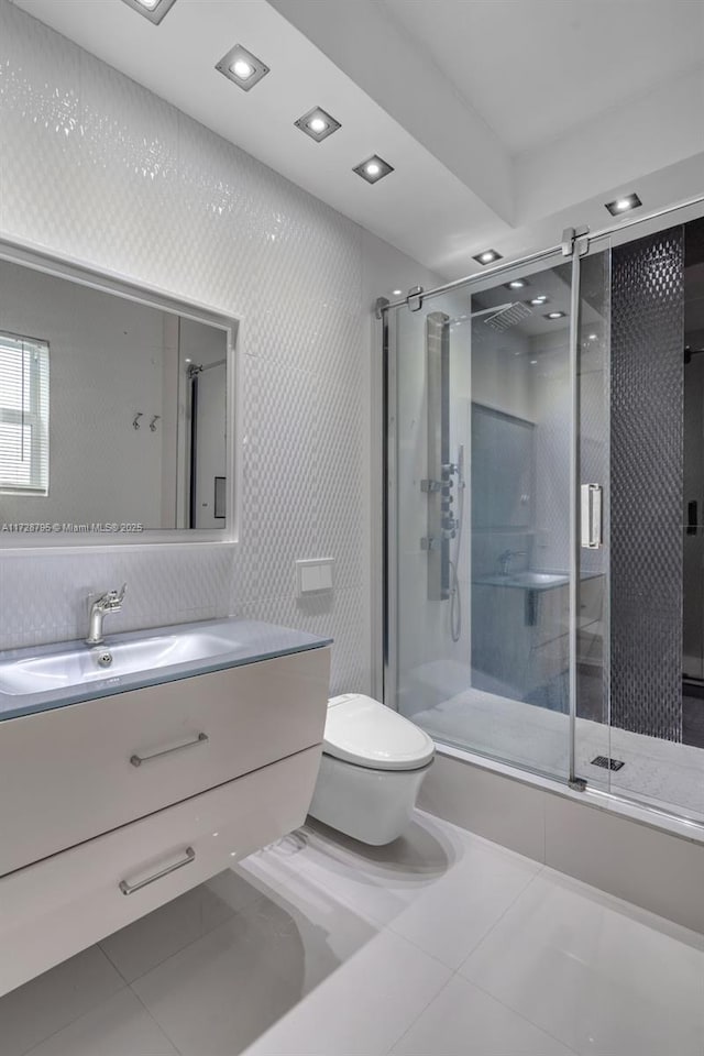 bathroom with an enclosed shower, vanity, toilet, and tile patterned flooring