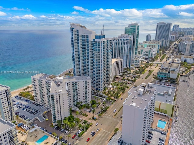 birds eye view of property with a water view and a view of city