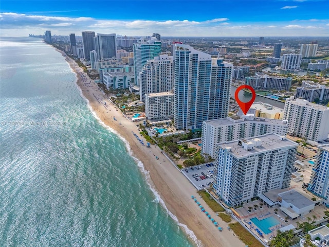 bird's eye view featuring a view of the beach and a water view