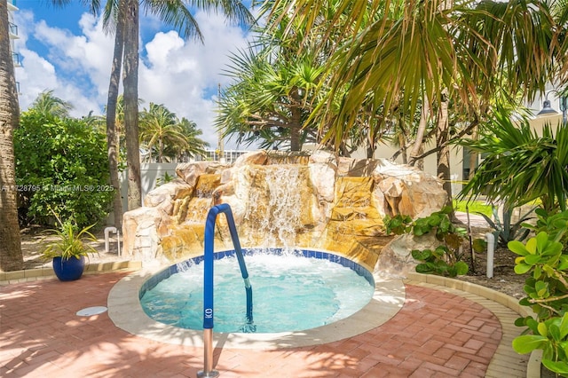 view of pool with an in ground hot tub