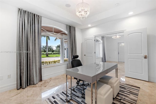 office featuring a raised ceiling and a notable chandelier