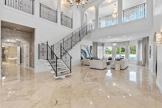 entryway featuring a chandelier and a high ceiling