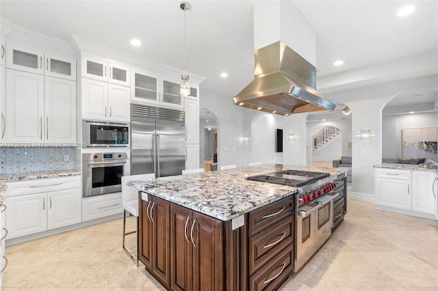 kitchen featuring a kitchen island, white cabinetry, island exhaust hood, built in appliances, and dark brown cabinets