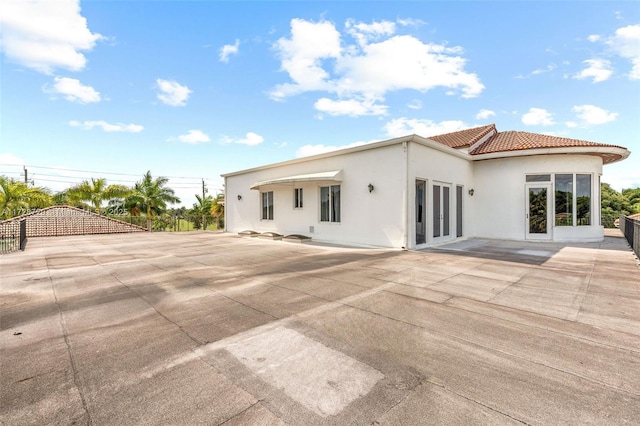 rear view of house featuring french doors and a patio area