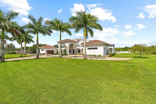 view of front of home with a front lawn and a garage