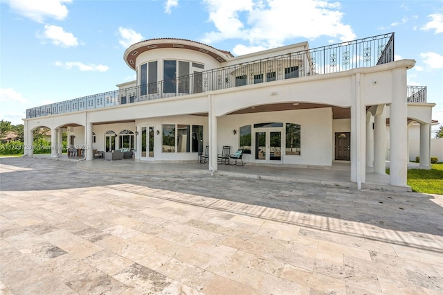 rear view of house featuring a patio area and french doors