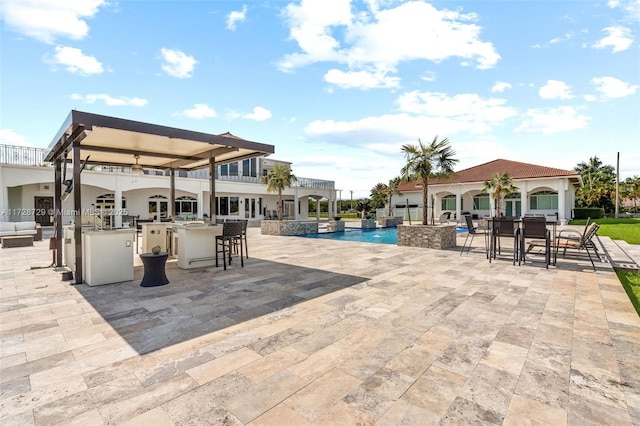 view of swimming pool featuring a bar and a patio