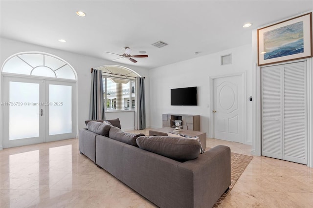 living room with ceiling fan and french doors