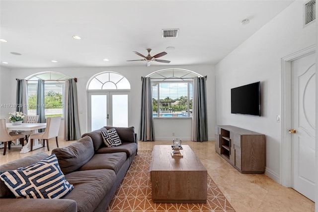 living room with ceiling fan and french doors