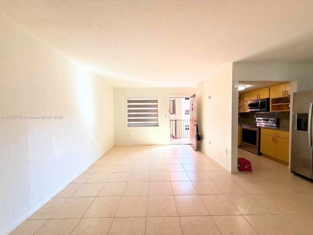 interior space featuring a textured ceiling and light tile patterned floors