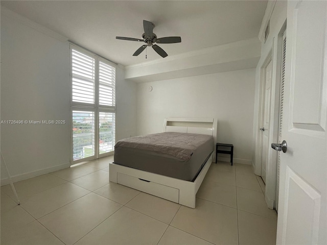 tiled bedroom featuring ceiling fan, ornamental molding, access to exterior, and multiple windows