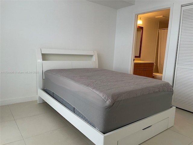 tiled bedroom with ensuite bath