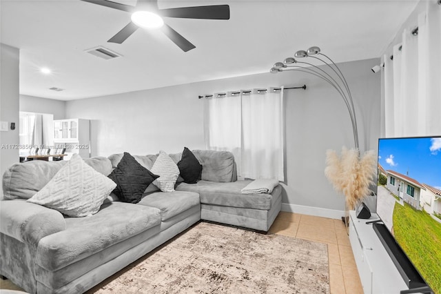 tiled living room featuring ceiling fan