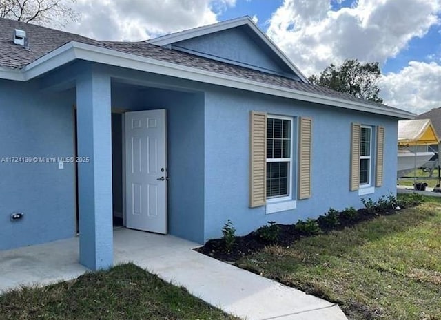 doorway to property with a yard