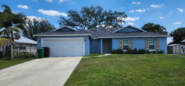 ranch-style home featuring driveway, a garage, stucco siding, a storage unit, and a shingled roof