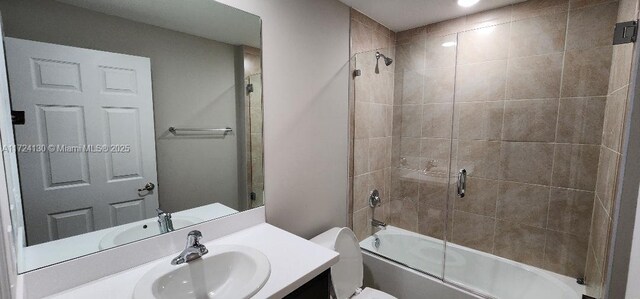 bathroom with vanity, shower / bath combination with glass door, toilet, and recessed lighting