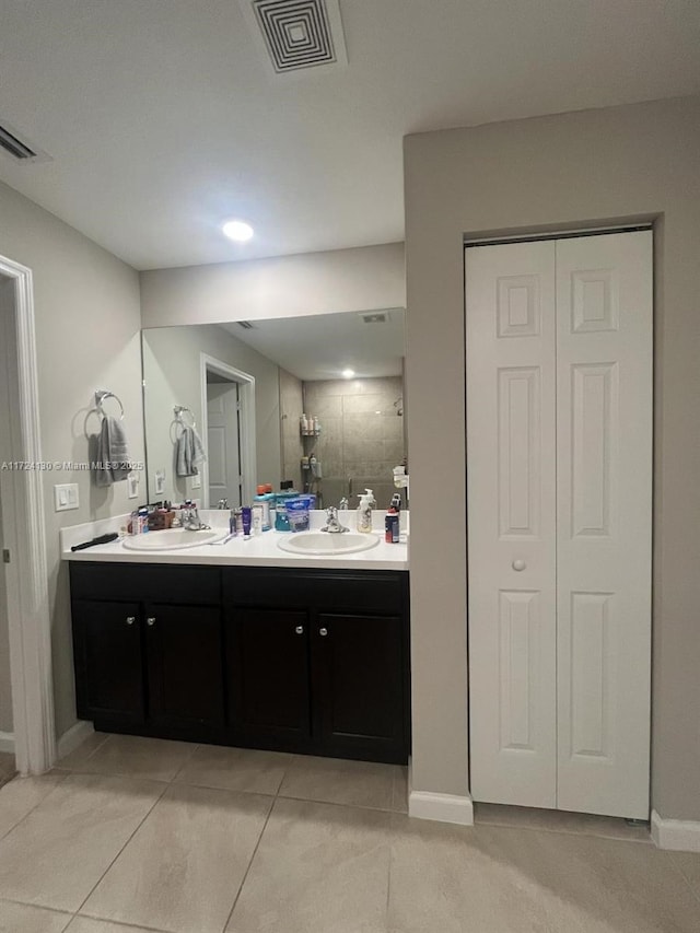 bathroom featuring tile patterned flooring and vanity