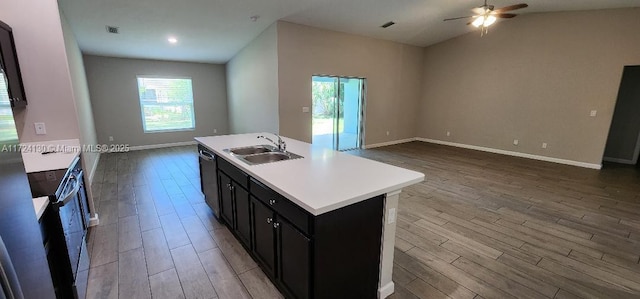 kitchen featuring a sink, open floor plan, dark wood-type flooring, plenty of natural light, and lofted ceiling