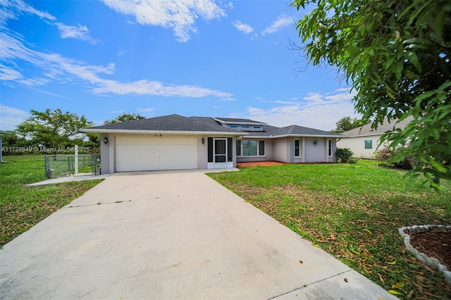 ranch-style house featuring a garage and a front lawn