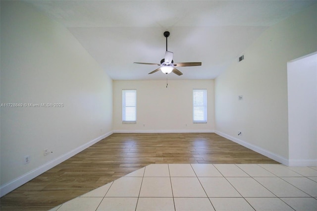 tiled spare room with ceiling fan