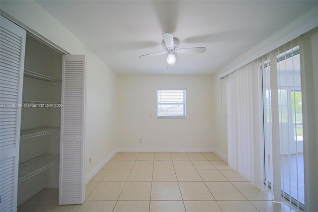 unfurnished bedroom with ceiling fan and light tile patterned floors