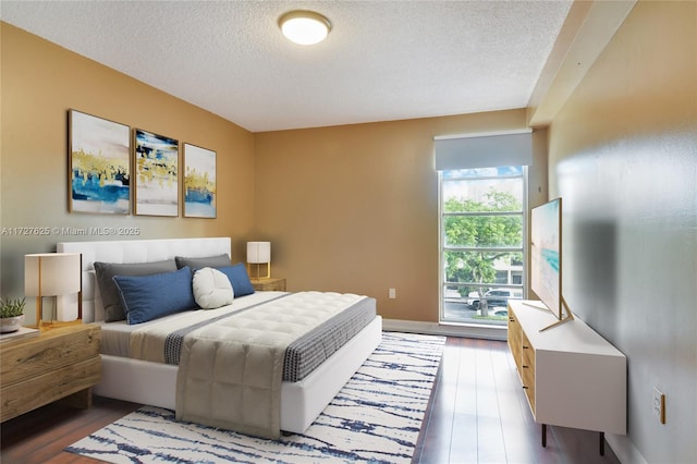 bedroom featuring a textured ceiling and hardwood / wood-style floors