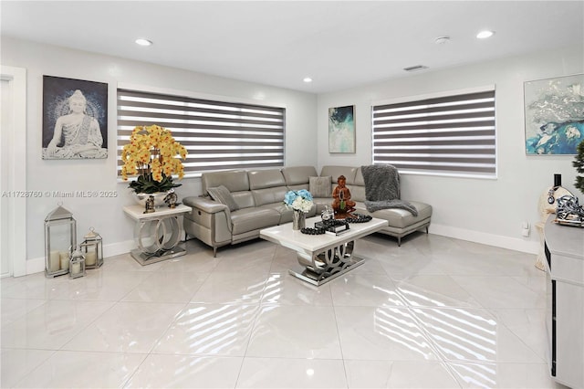 tiled living room featuring a healthy amount of sunlight