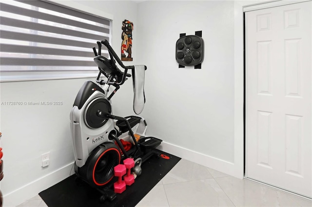 workout room featuring light tile patterned flooring