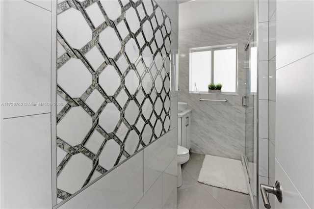 bathroom with tile patterned floors, toilet, and walk in shower