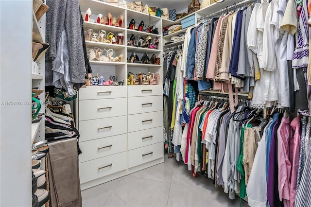 spacious closet featuring light tile patterned flooring