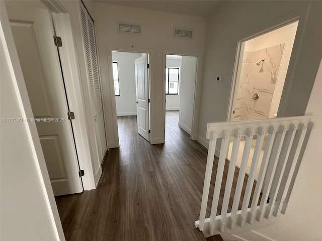 hallway with dark hardwood / wood-style flooring