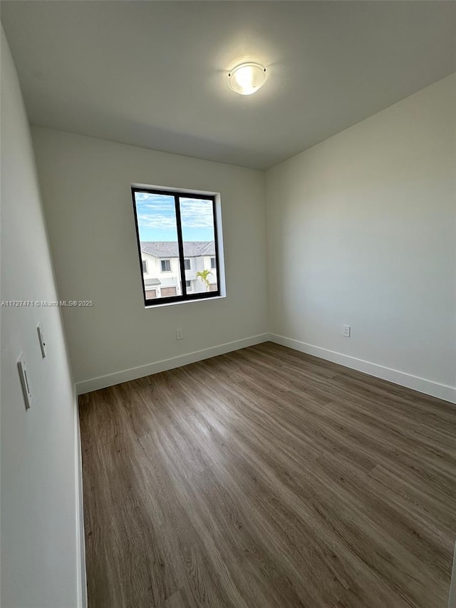 empty room with dark hardwood / wood-style floors