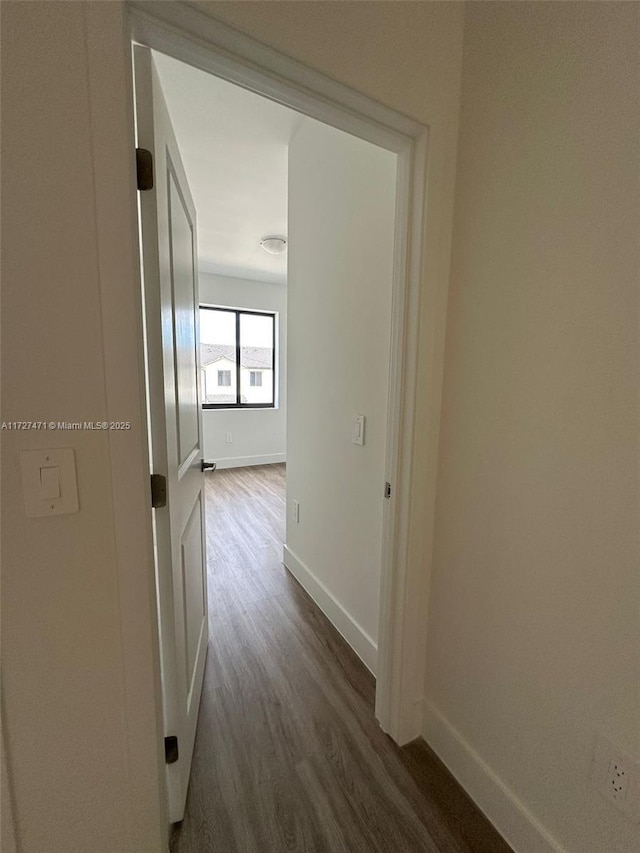 hallway with dark hardwood / wood-style flooring