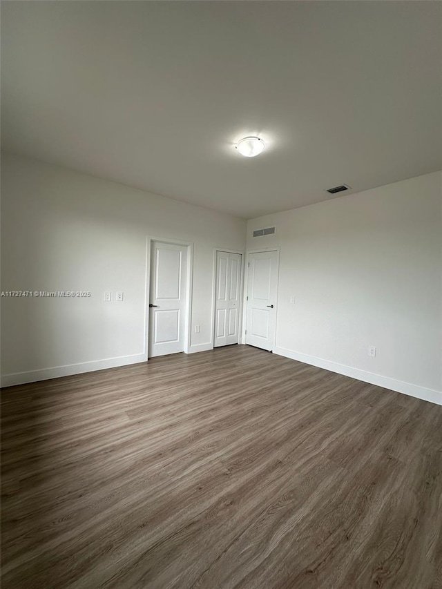 unfurnished room featuring dark hardwood / wood-style flooring