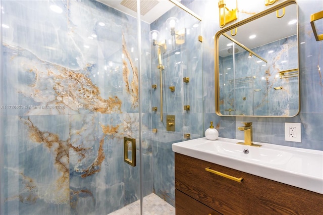 bathroom featuring an enclosed shower and vanity