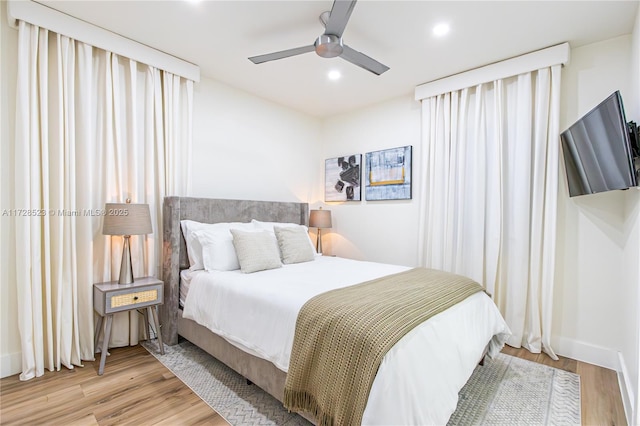 bedroom with ceiling fan and light hardwood / wood-style floors