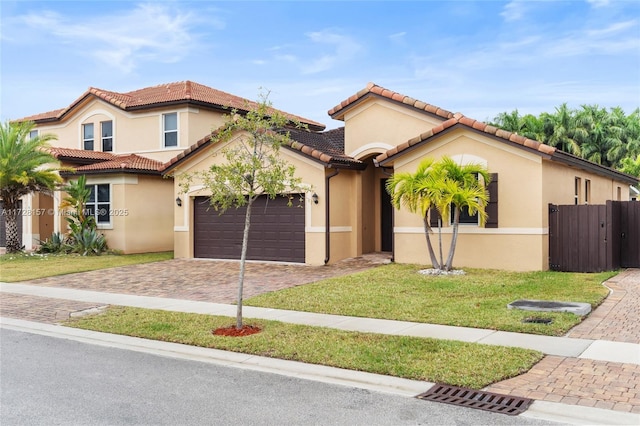 mediterranean / spanish-style home featuring a garage and a front yard