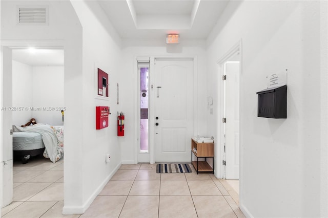 entryway with light tile patterned flooring