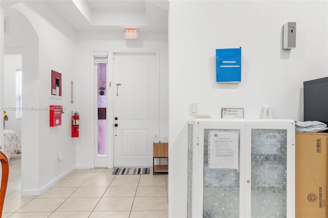 foyer entrance with light tile patterned floors