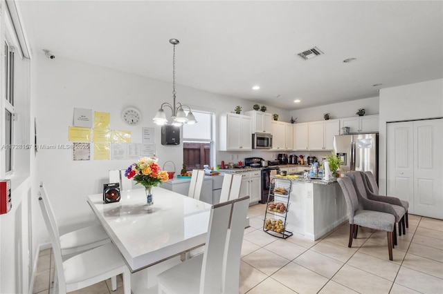 tiled dining room featuring a chandelier