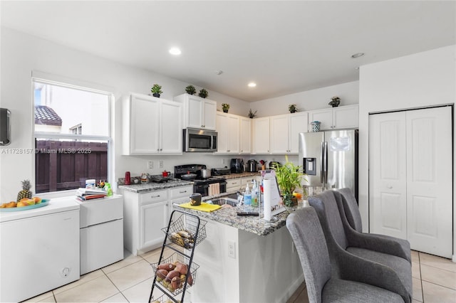 kitchen featuring light stone counters, white cabinets, and appliances with stainless steel finishes