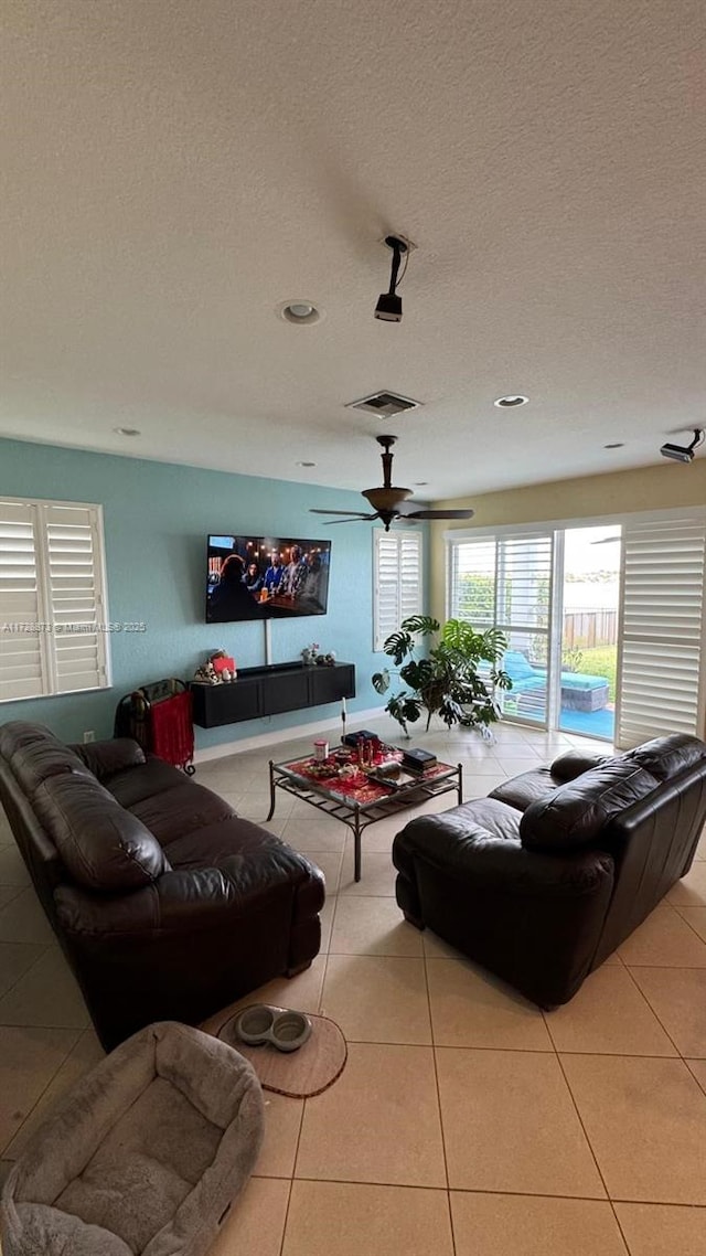 living room featuring a textured ceiling and light tile patterned flooring