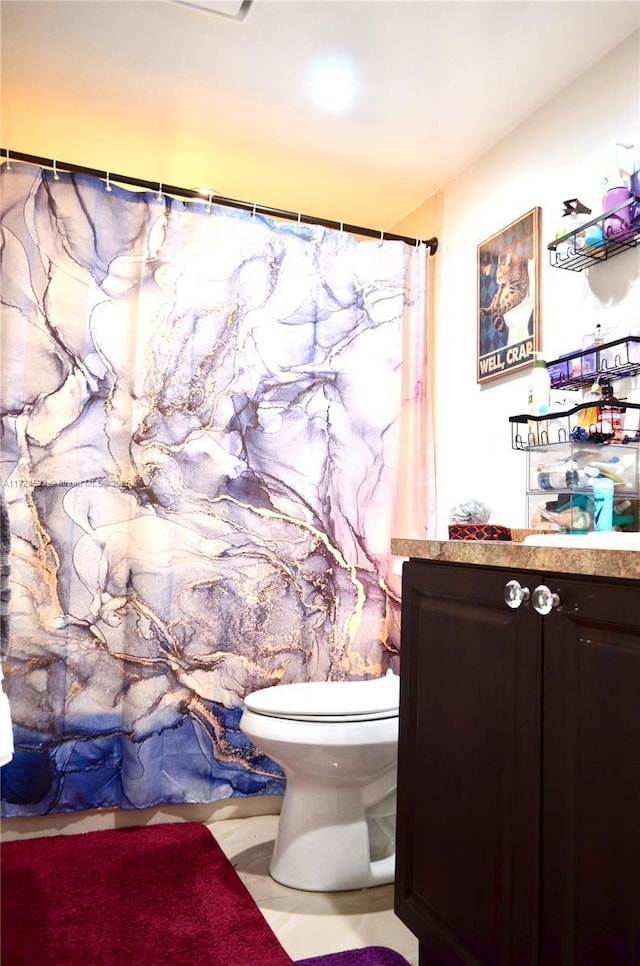 bathroom with vanity, a shower with shower curtain, and toilet