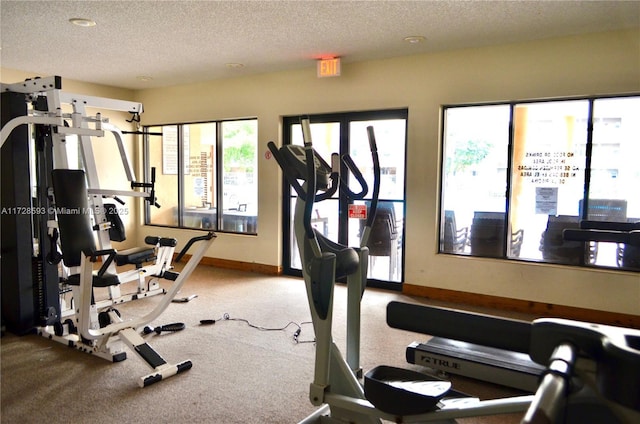 exercise room featuring a textured ceiling