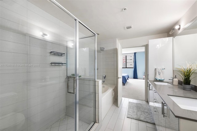 bathroom with vanity and independent shower and bath