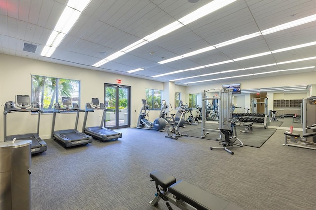 exercise room featuring a paneled ceiling and french doors