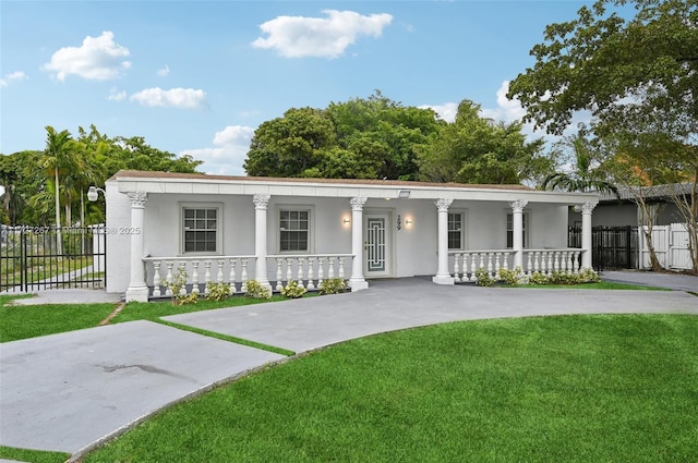 view of front of home with a front yard and covered porch