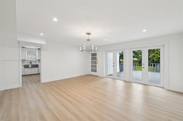 299 S Biscayne River Dr, Miami, FL 33169 - unfurnished living room with light wood-type flooring, a chandelier, recessed lighting, french doors, and baseboards